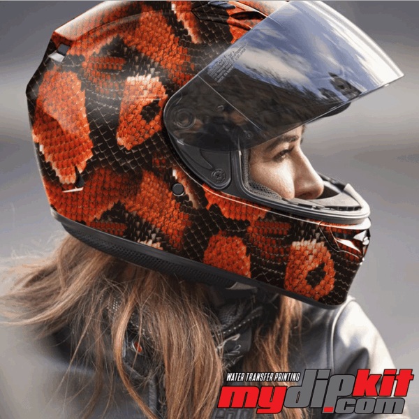 Blonde woman wearing a motorcycle helmet covered in red cobra skin pattern through hydro dip.